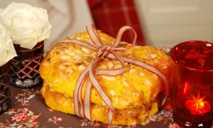 Två gyllene saffransbullar, bundna med ett band, med mandel och en röd lykta.