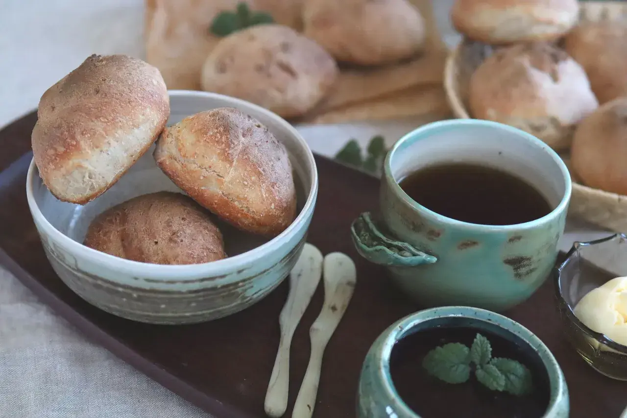 Nybakade bullar, resultatet av noggrann knådning, serveras med te och smör.