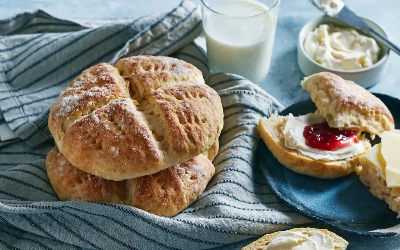 Färska scones, redo att avnjutas med sylt och grädde. En perfekt sconesdeg ger dessa bakverk sin härliga textur.